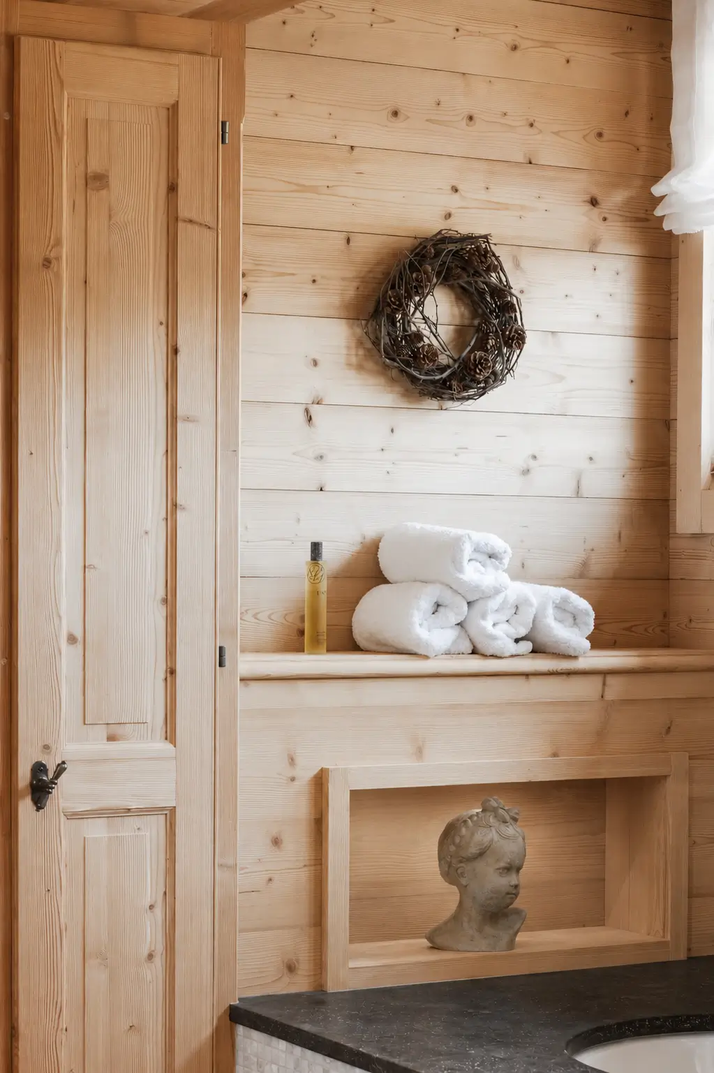 Timber-panelled bathroom alcove with soft alpine light