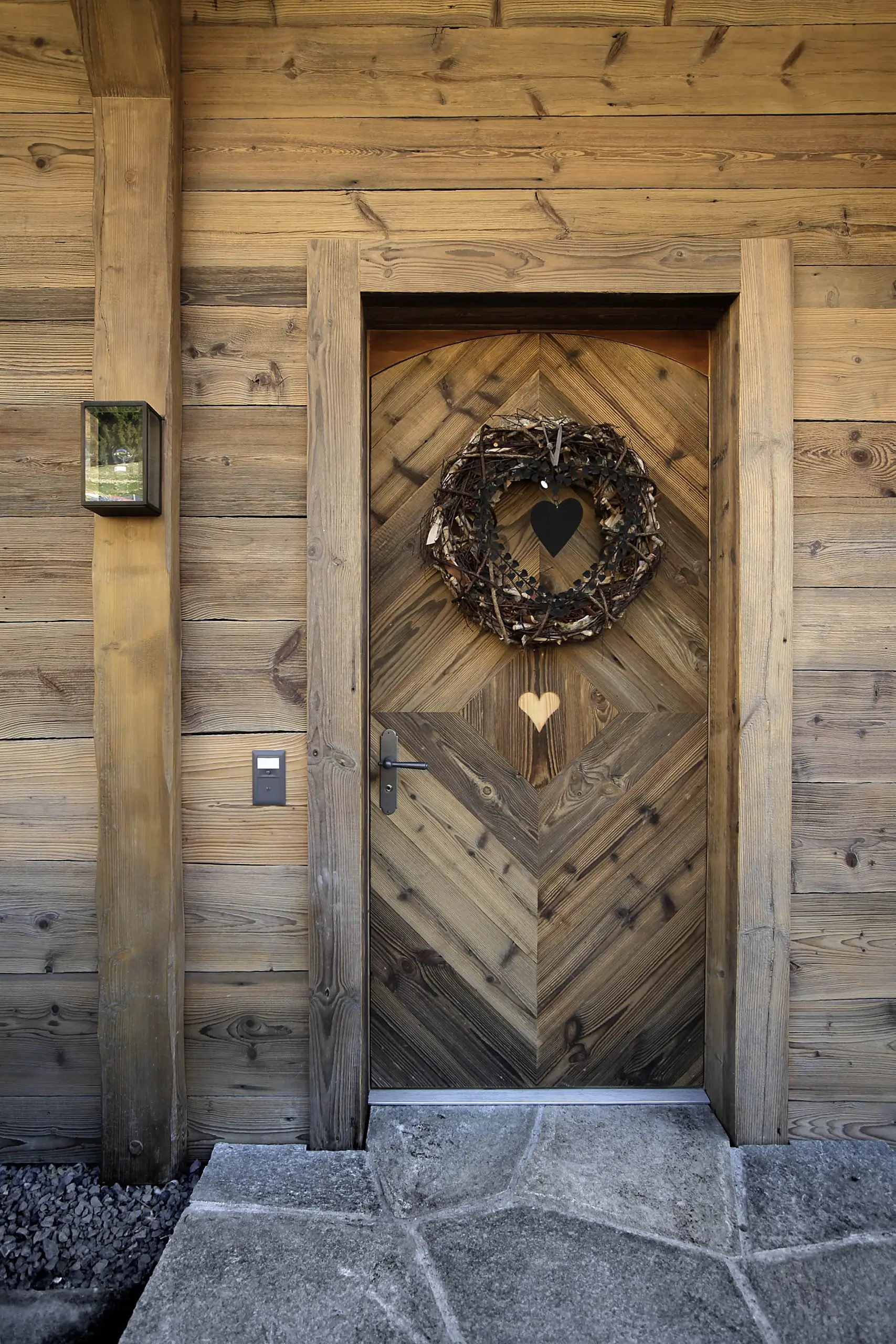 Sculptural timber entrance door of the chalet