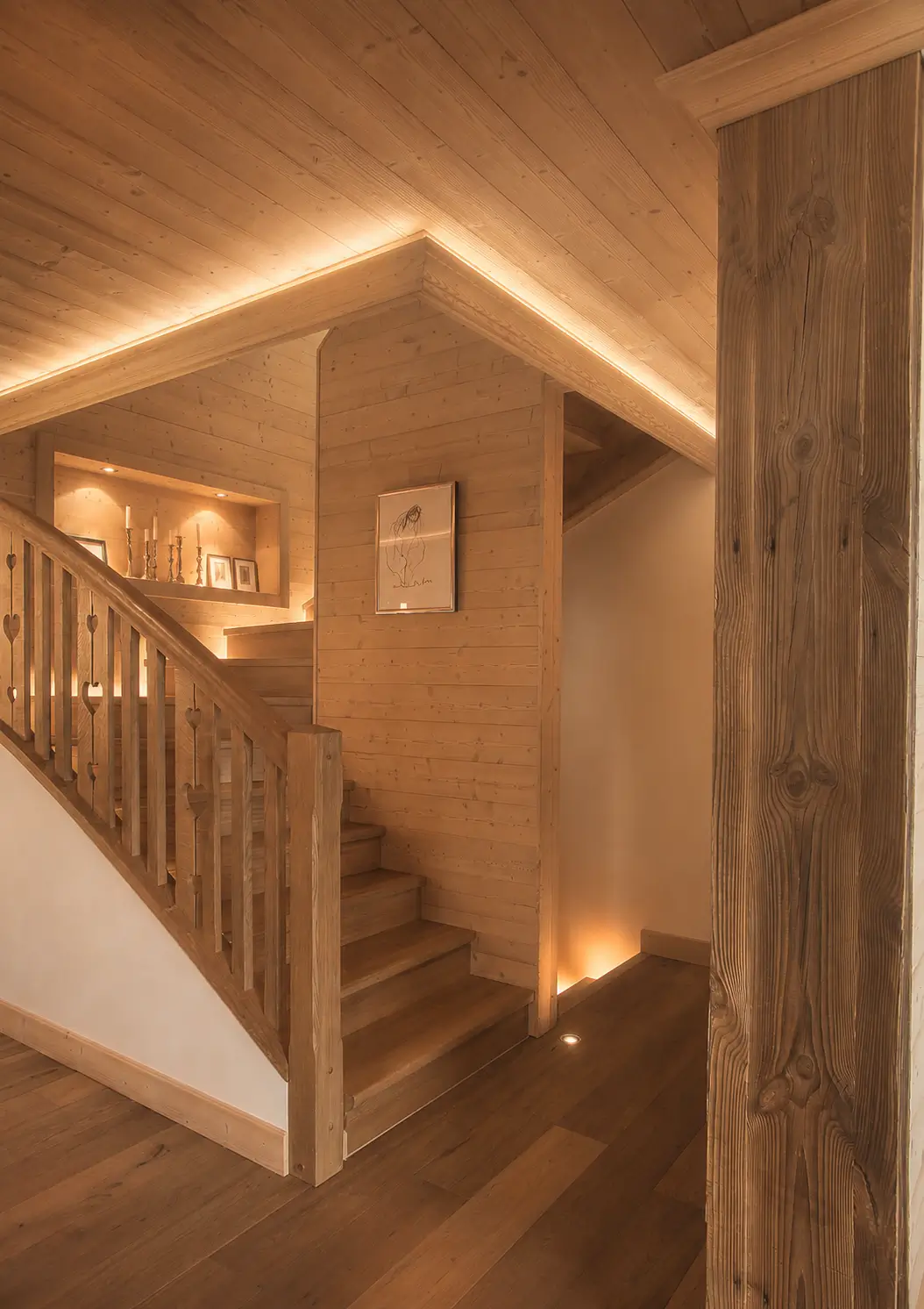 Entrance hall and sculptural staircase washed in indirect light
