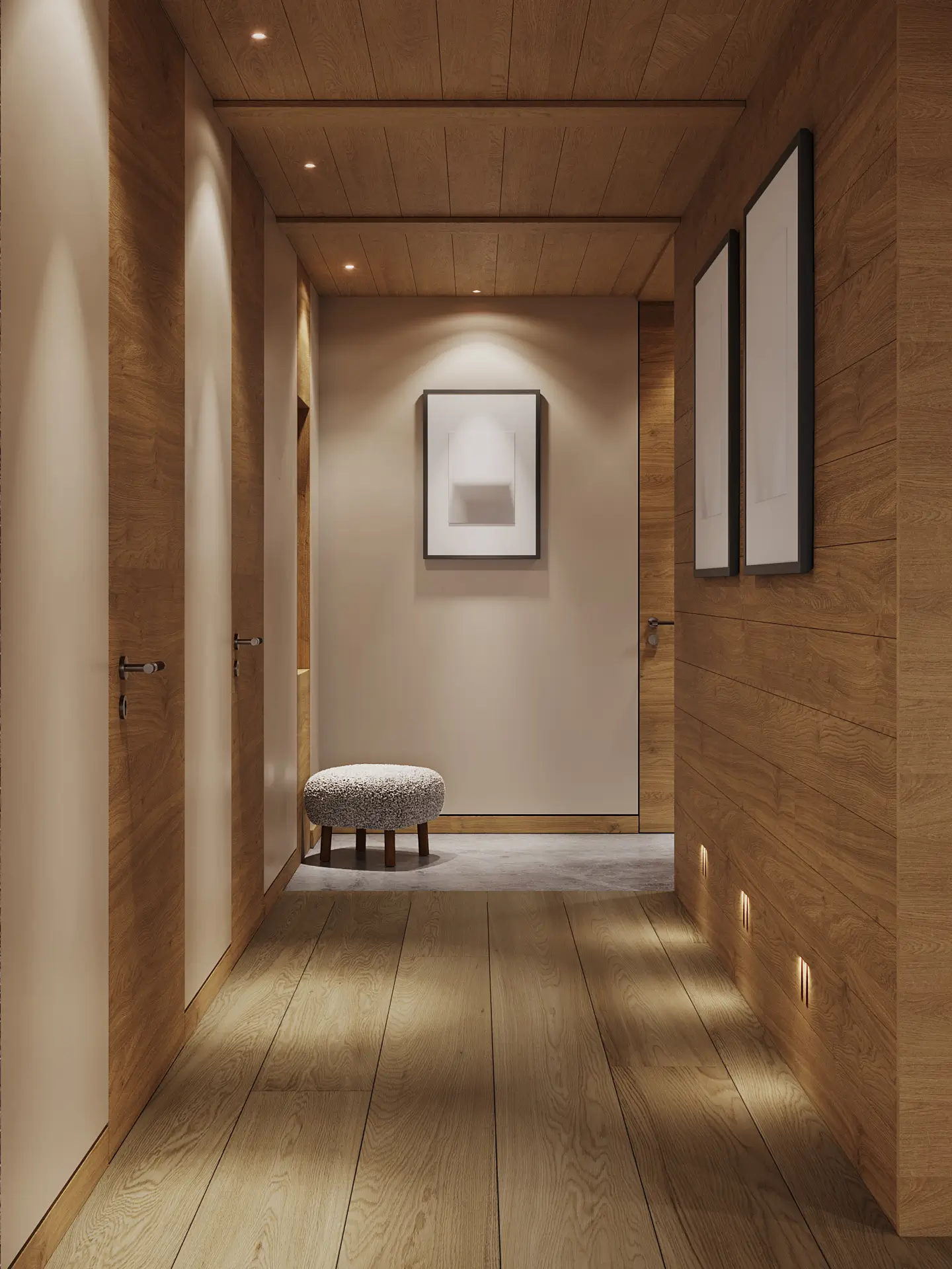 Warmly lit entrance hall lined in oak panelling with floor-level lighting, framed artworks and a bouclé upholstered stool