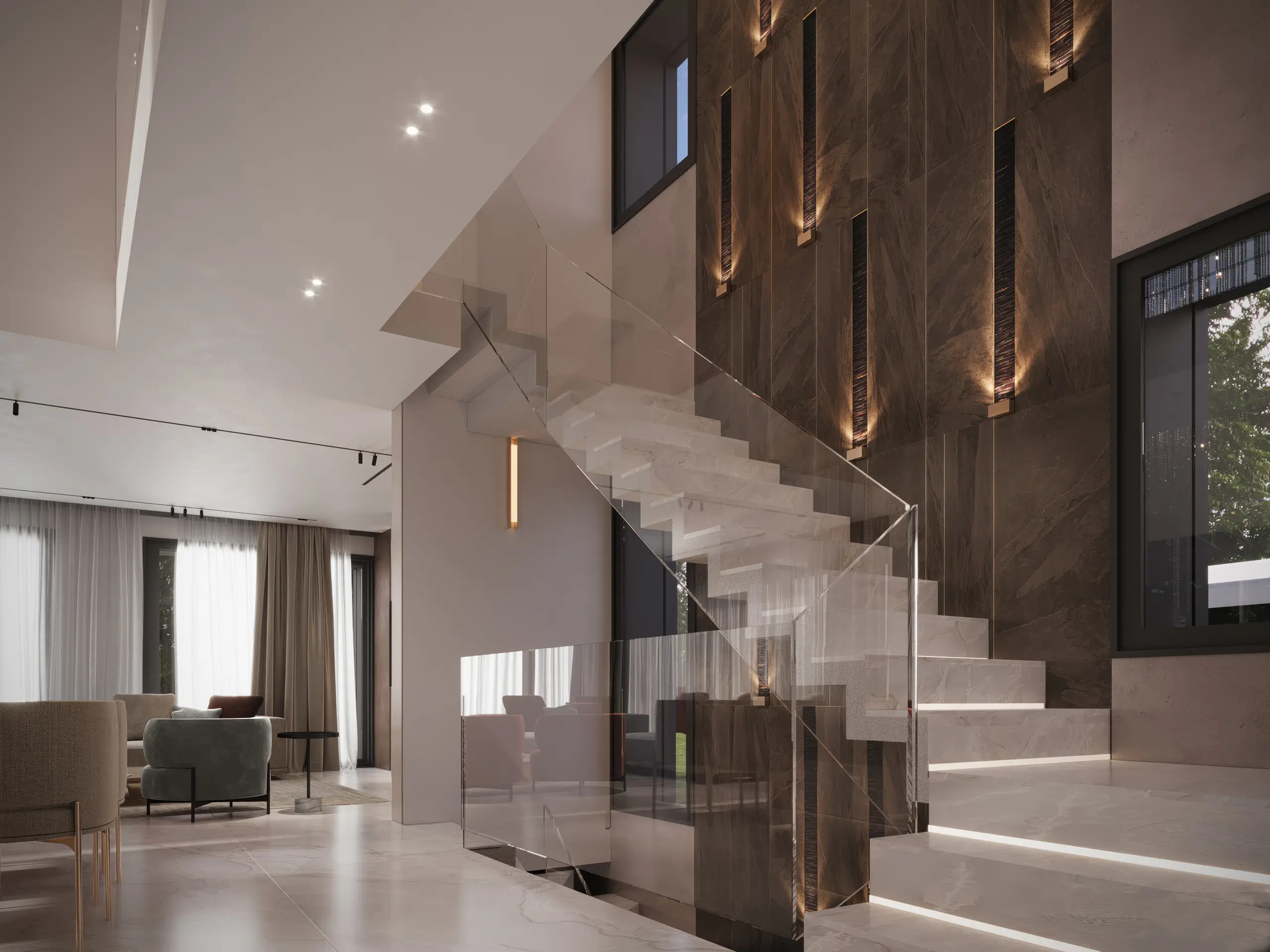 Villa D double-height staircase hall with floating stone treads, glass balustrade, and an illuminated dark stone wall beside an open living area