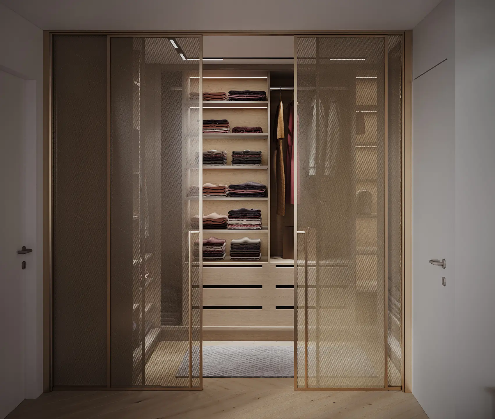 Villa D walk-in wardrobe with bronze-framed glass sliding doors enclosing backlit timber shelving and folded garments