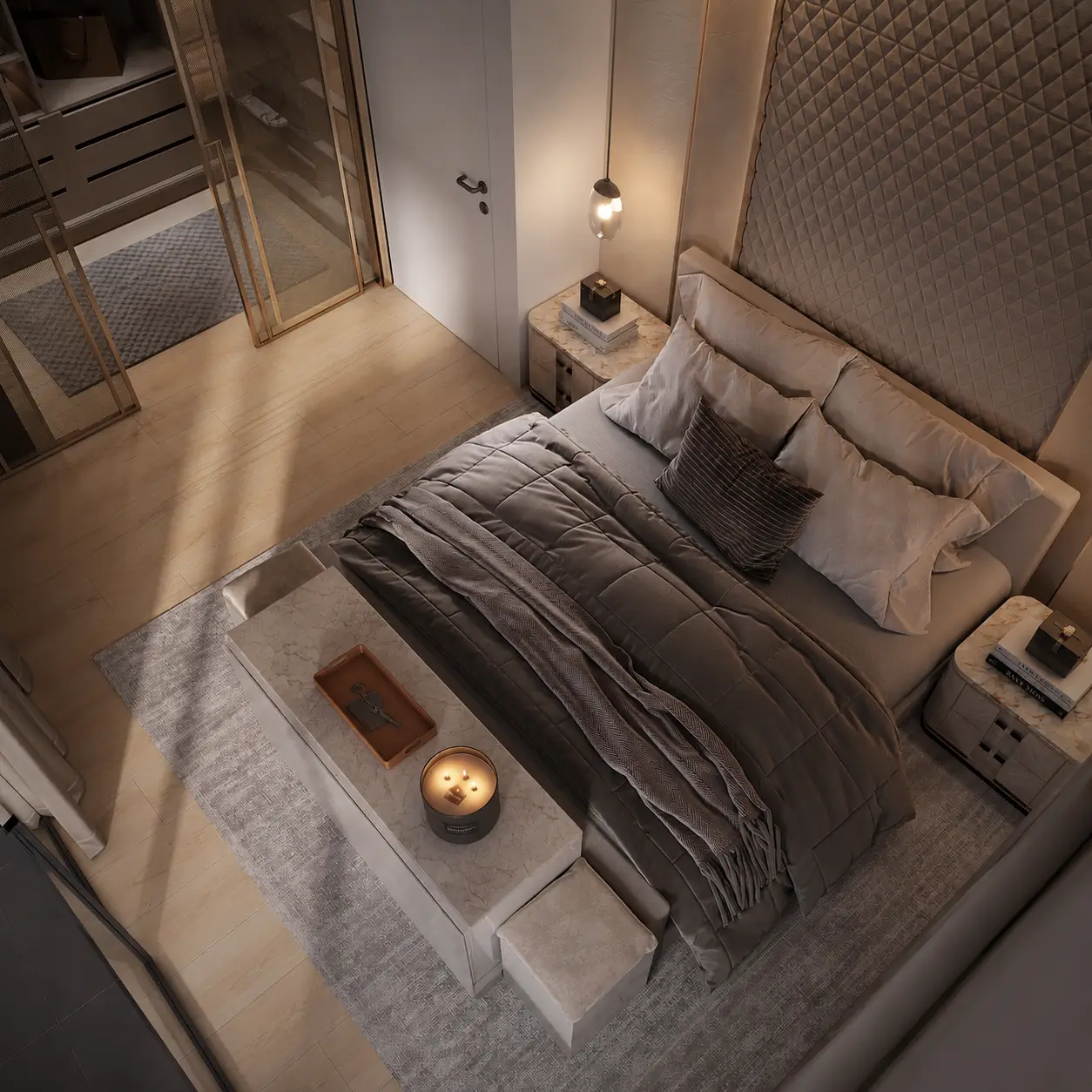 Villa D bedroom seen from above, showing the diamond-quilted headboard, layered grey bedding, and a brass-framed glass partition to the dressing area