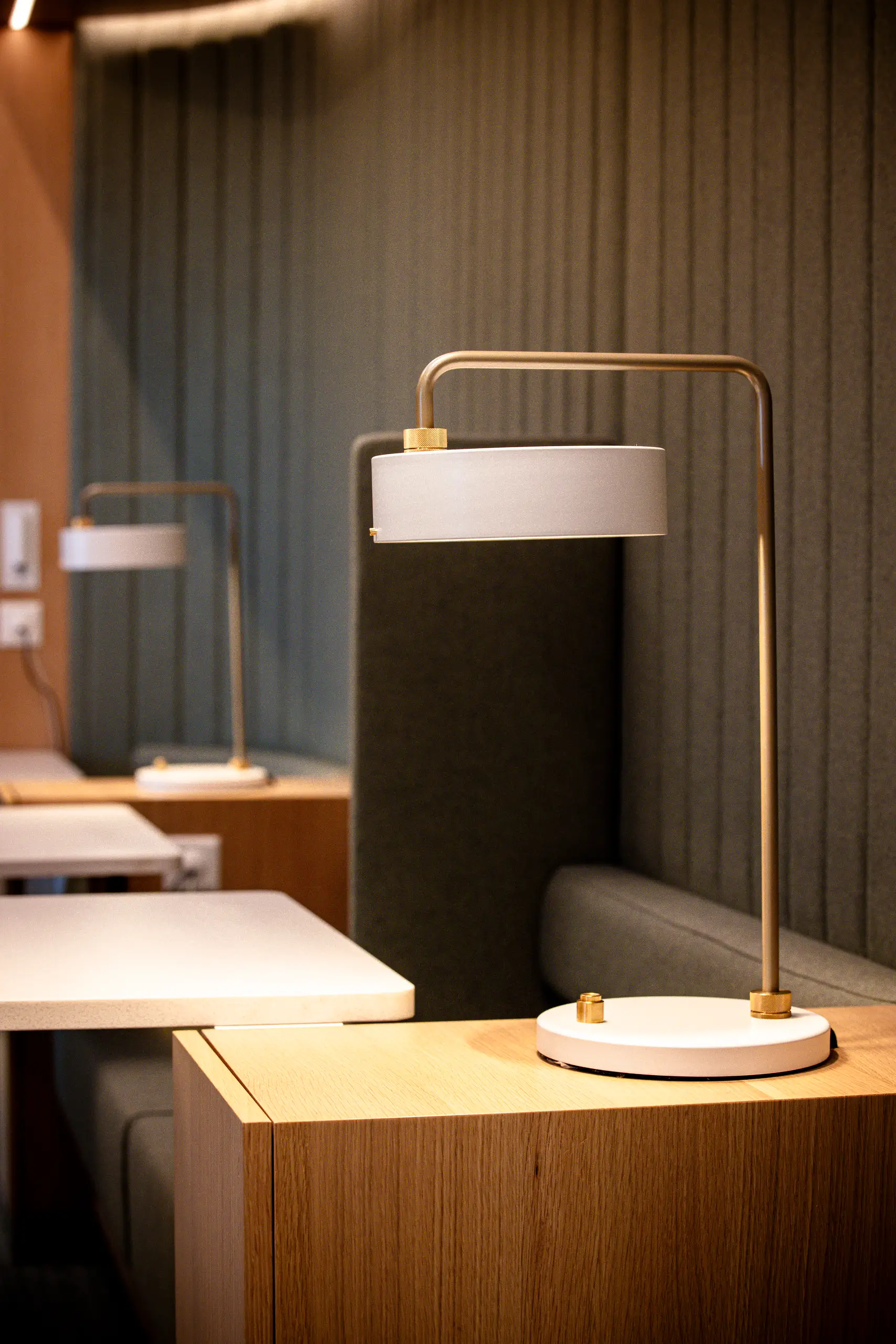 Detail of the Hotdesk's oak veneer, residential focus lamp and acoustic divider