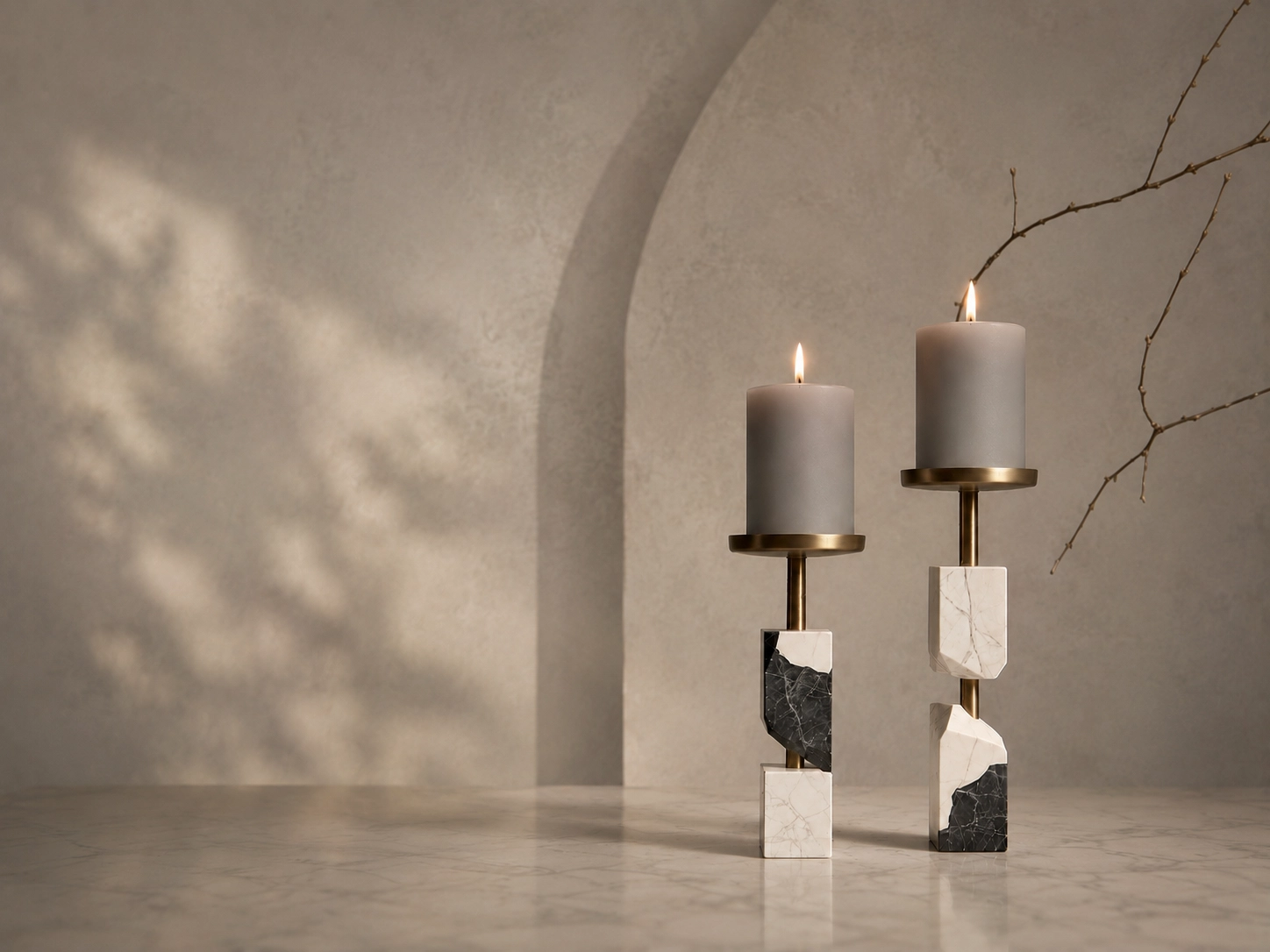 Marble and brass candleholders with lit candles